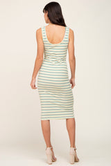 woman wearing a striped midi tank dress in green and white, showing the back view and form-fitting design
