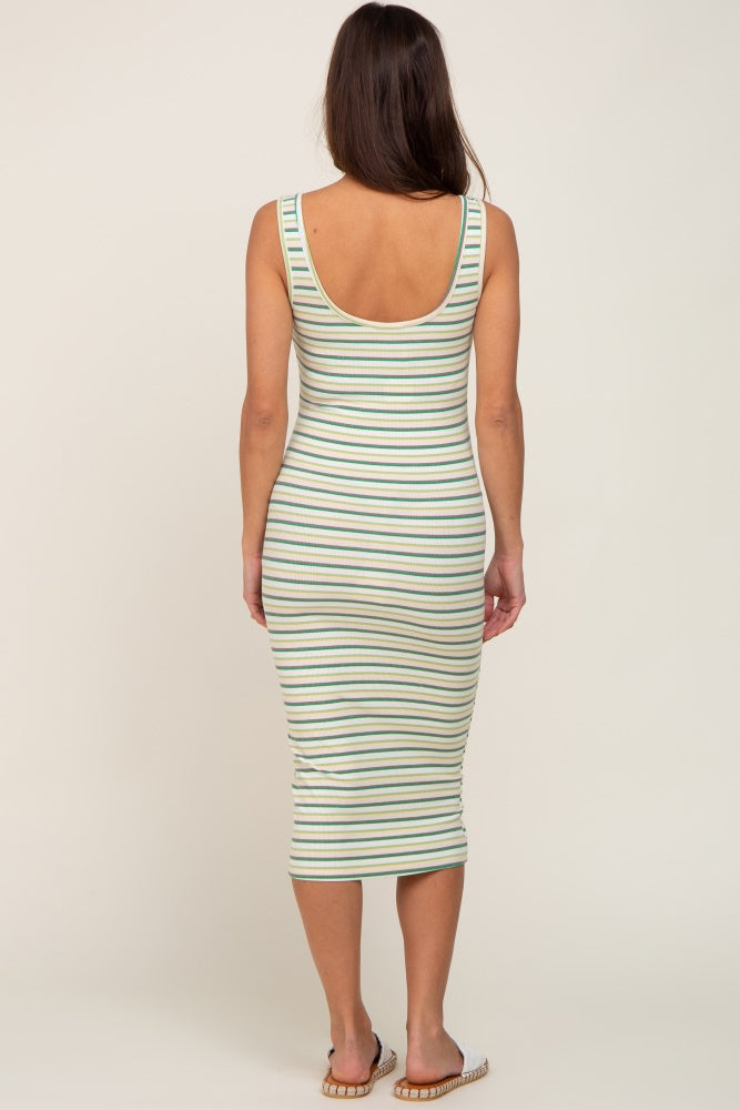 Back view of a woman wearing a green and yellow striped ribbed midi dress with a scoop back.