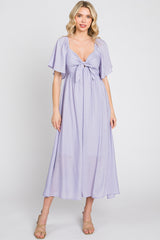 woman wearing a lavender maxi dress with a tie front and short flutter sleeves
