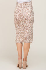 woman wearing a beige patterned maternity pencil skirt, shown from the back, with a fitted silhouette