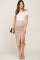 woman wearing a fitted white off-the-shoulder maternity top and a beige animal print ruched maternity skirt showcasing a baby bump