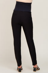 woman wearing black maternity pants with a high waistband, viewed from the back