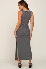 woman wearing a black and white striped maternity maxi dress with side slits