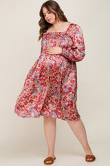 Pregnant woman in a floral smocked maternity dress with long sleeves and a square neckline
