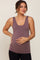 woman wearing a mauve maternity tank top and gently cradling her baby bump