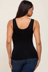woman wearing a black scoop neck tank top, seen from the back, paired with blue jeans