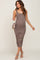 woman wearing a brown maternity midi dress with side ruching and holding a small purse, showing her baby bump