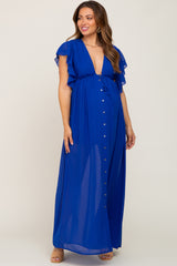woman wearing a royal blue maternity maxi dress with ruffled sleeves and a low v-neckline, showing her baby bump