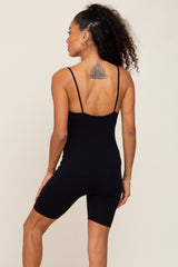 woman wearing a black ribbed bodysuit with spaghetti straps and a fitted style, shown from the back