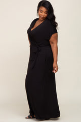 plus size woman wearing a black short sleeve wrap maxi dress with a waist tie