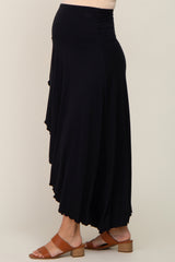 woman wearing a black maternity maxi skirt with a high waistband and brown block heel sandals