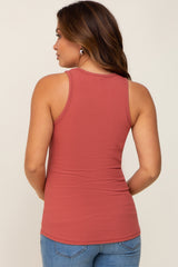 woman wearing a rust-colored ribbed maternity tank top, seen from the back