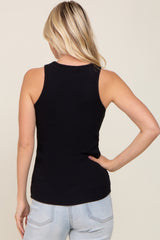 woman wearing a black ribbed sleeveless tank top, seen from the back, paired with light blue jeans