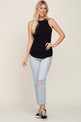 woman wearing a black ribbed sleeveless top and light blue distressed jeans with black sneakers