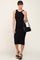 woman wearing a sleeveless black ribbed midi dress with a black shoulder bag and platform sandals