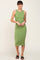 woman wearing a sleeveless green ribbed midi dress and black sandals against a neutral background
