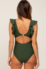 woman wearing a dark green one-piece swimsuit with ruffled straps and an open back detail