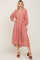 woman wearing a red floral tiered midi dress with long sleeves and brown platform sandals
