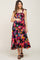 pregnant woman wearing a colorful abstract print smocked maternity midi dress with tie straps
