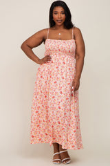 woman in a pink floral smocked maxi dress with spaghetti straps and white sandals