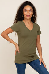 woman wearing olive green v-neck short sleeve t-shirt and blue jeans