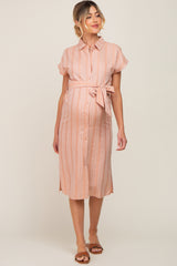 pregnant woman wearing a pink striped maternity shirt dress with a waist tie and brown sandals