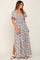 woman wearing a floral smocked maxi dress with flutter sleeves and side slit