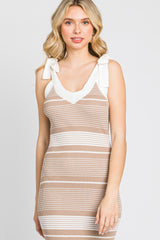 woman wearing a beige and white striped bodycon dress with tie shoulder details