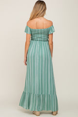 woman wearing a mint green striped off-the-shoulder maternity maxi dress with ruffle hem and smocked bodice