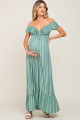 woman wearing a green striped off-the-shoulder maternity maxi dress and showing her baby bump