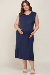 woman wearing a navy blue sleeveless maternity dress with side slits and a pocket, showcasing her baby bump