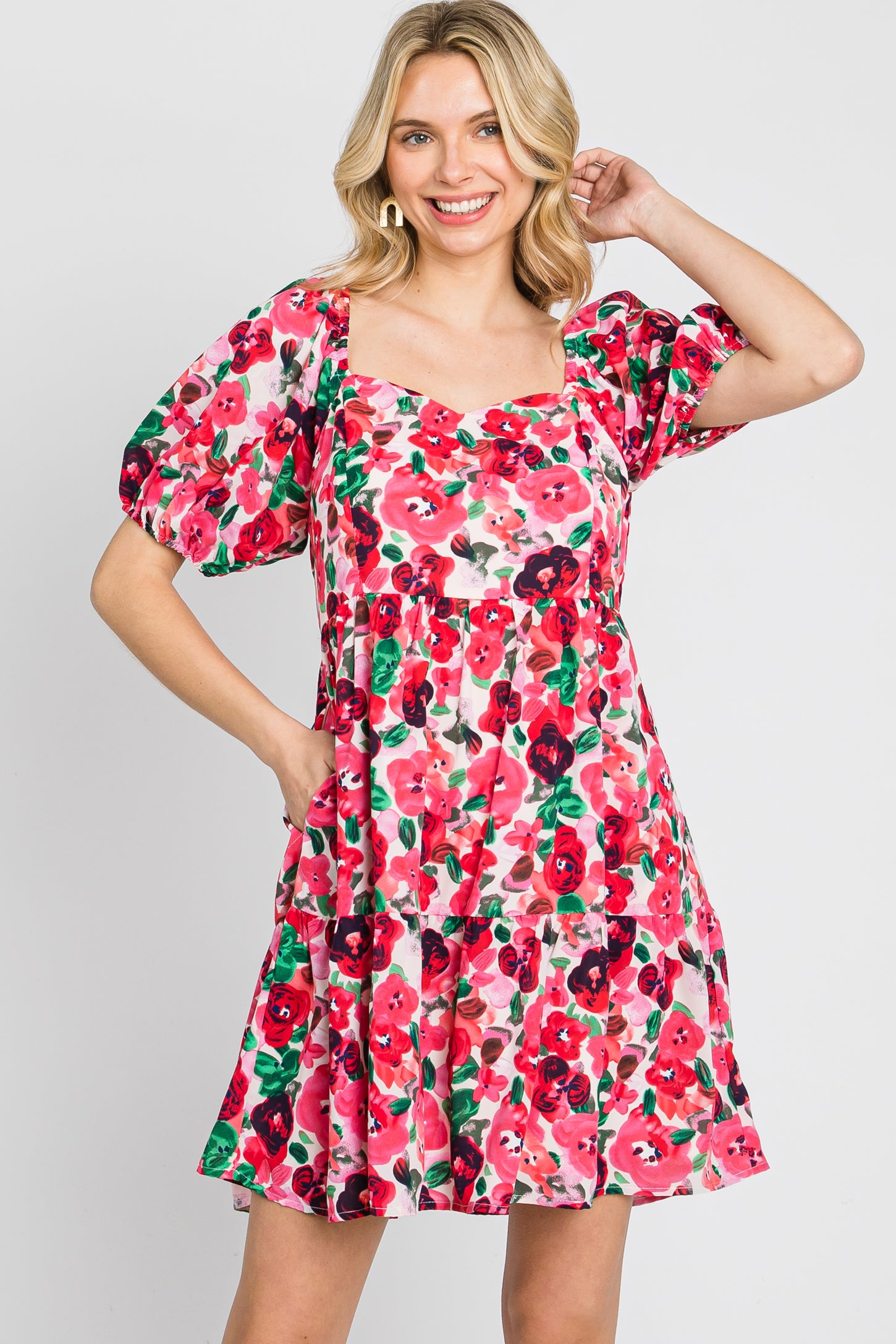 blonde woman wearing a pink and red floral print mini dress with puff sleeves and a square neckline