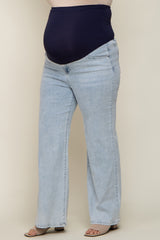 woman wearing light blue maternity plus jeans with a navy blue over-the-bump waistband and flared leg style