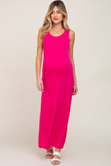 woman wearing a hot pink sleeveless maternity maxi dress with white sandals