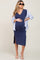 Pregnant woman wearing a navy blue maternity midi dress and a striped button-down shirt with sunglasses
