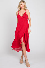 woman wearing a red floral midi wrap dress with a side slit and adjustable spaghetti straps