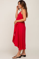 woman wearing a red floral maternity dress with a ruffled hem and a visible baby bump