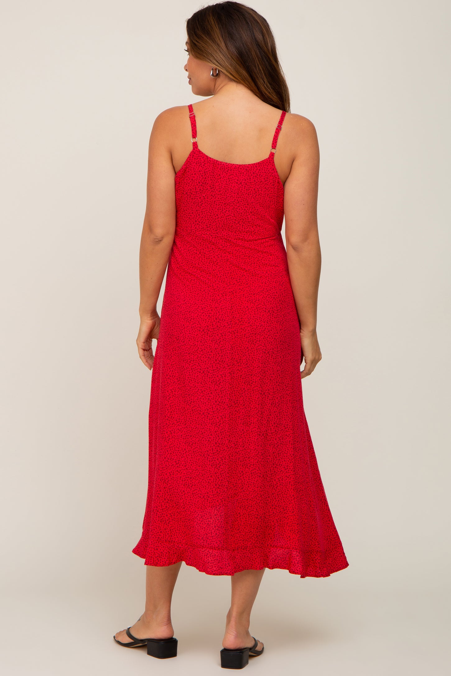 woman wearing a red maternity midi dress with adjustable straps, showing a flowy silhouette and soft fabric