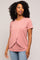 Woman wearing a dusty rose short-sleeve nursing top with a crossover front detail and blue jeans