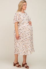 Pregnant woman wearing a floral pleated maternity midi dress and brown braided heels