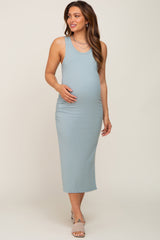 woman wearing a light blue tank maternity dress with side ruching and holding her baby bump