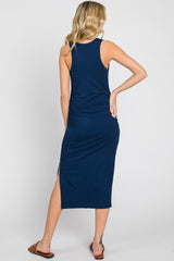woman wearing a navy blue bodycon maxi dress with a side slit, shown from the back
