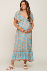 pregnant woman wearing a light blue floral maternity maxi dress with short sleeves and v-neckline