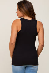 woman wearing a black maternity tank top, viewed from the back, paired with light blue jeans