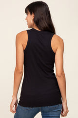 woman wearing a black sleeveless ribbed tank top and blue jeans, viewed from the back