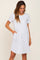 woman wearing a light gray short sleeve t-shirt dress with pockets and a relaxed fit