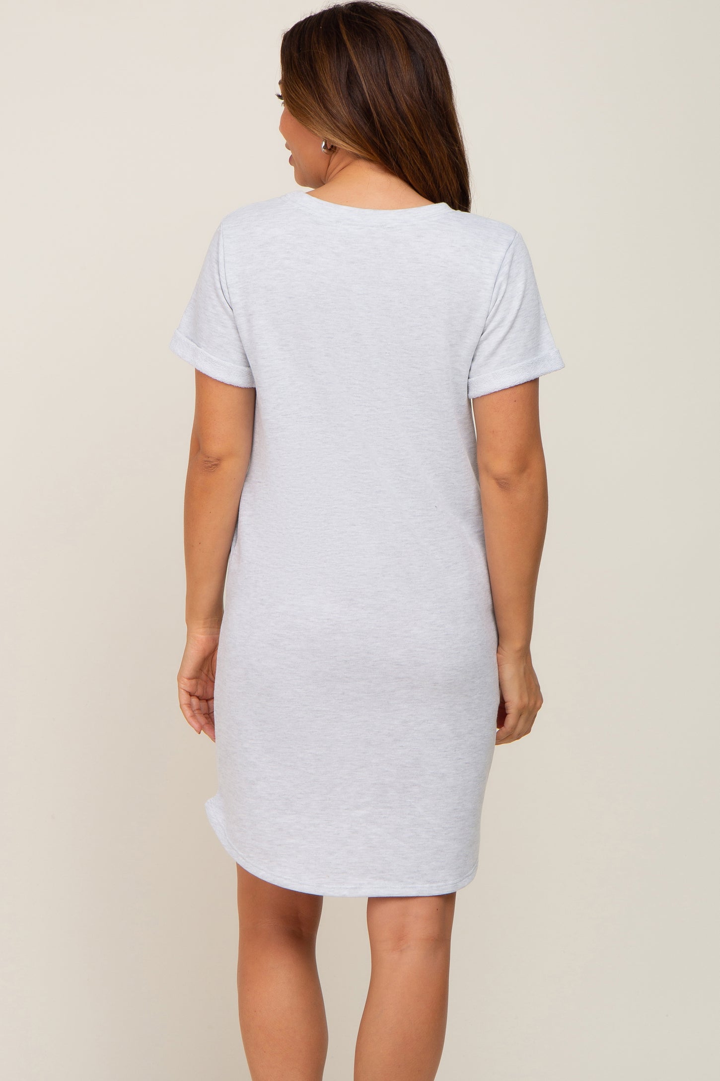 woman wearing a light gray short sleeve maternity dress, shown from the back