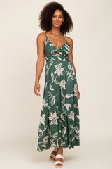 woman wearing a green floral print maxi dress with a cutout bodice and tiered skirt