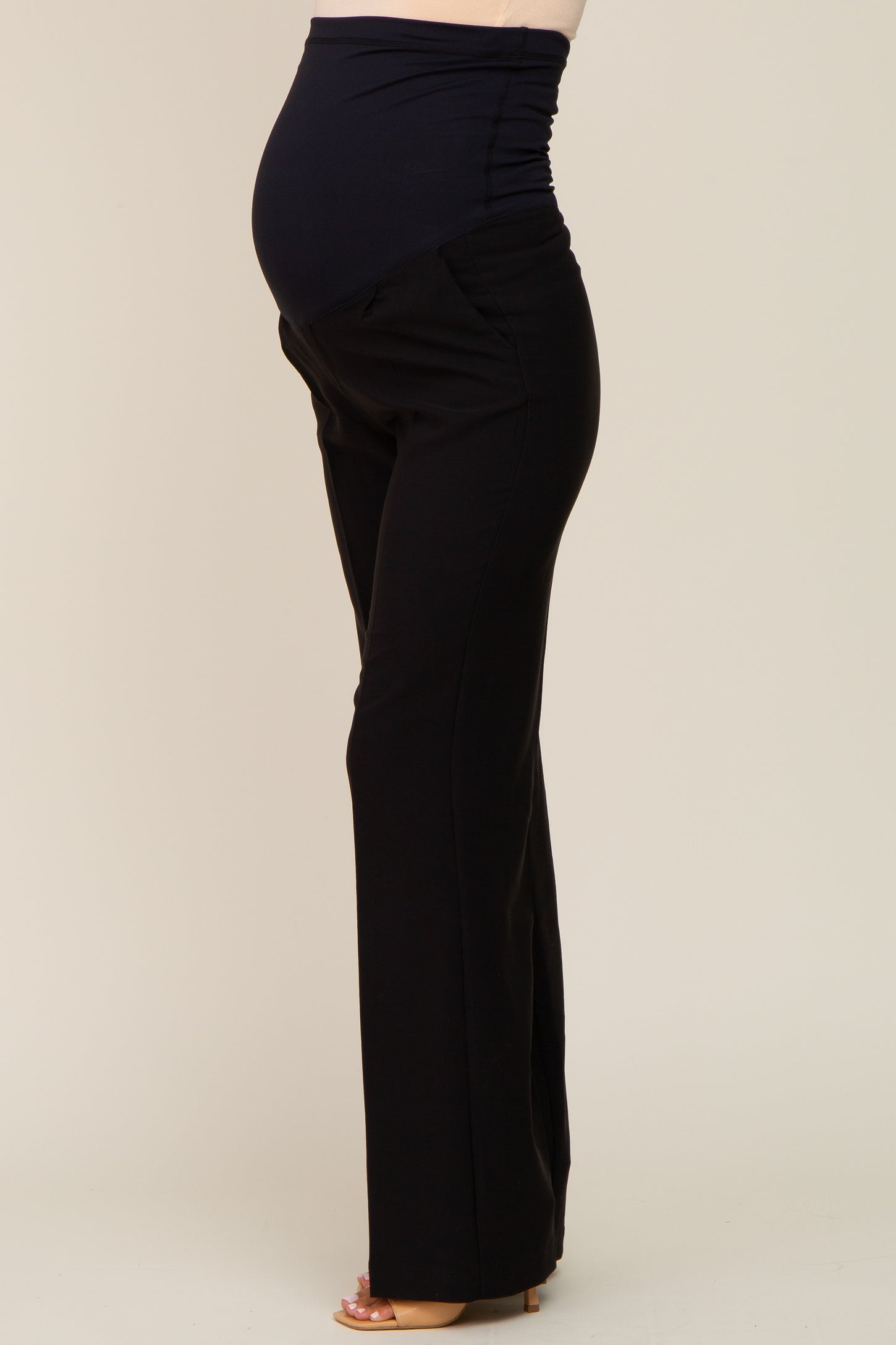 woman wearing black maternity pants with a stretchy waistband and visible baby bump