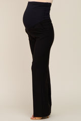 woman wearing black maternity pants with a stretchy waistband and visible baby bump